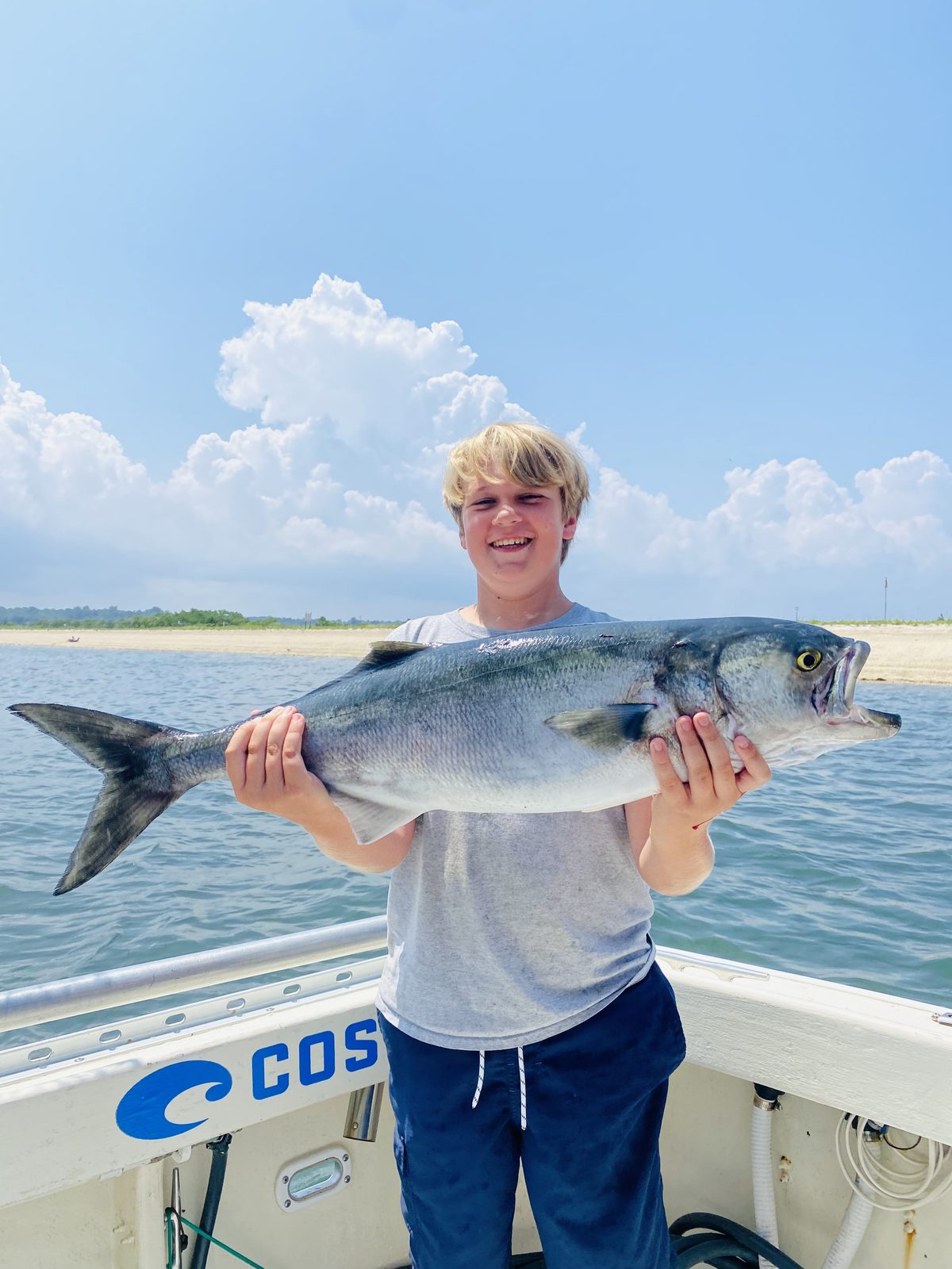 A young angler with a bluefish