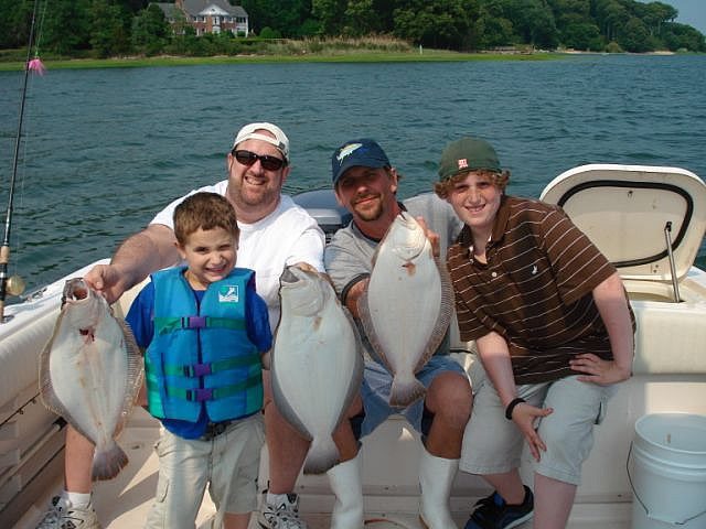 A family with their catch of fluke