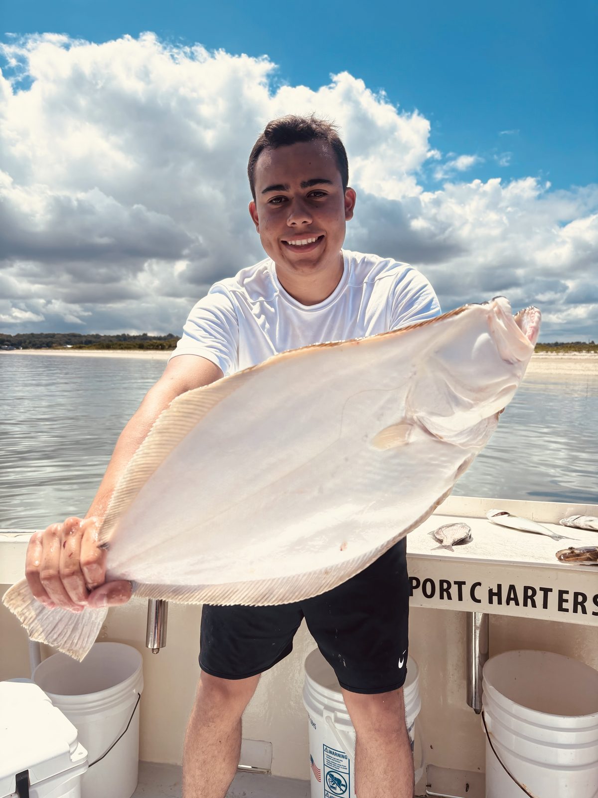 A young angler with a big fluke