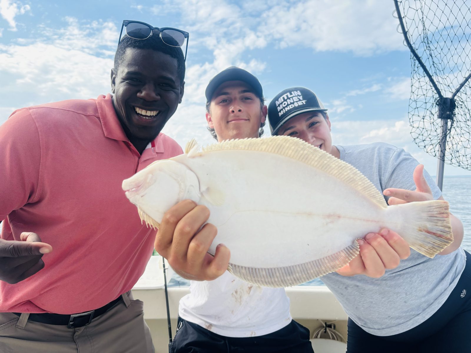 Three anglers with a fluke