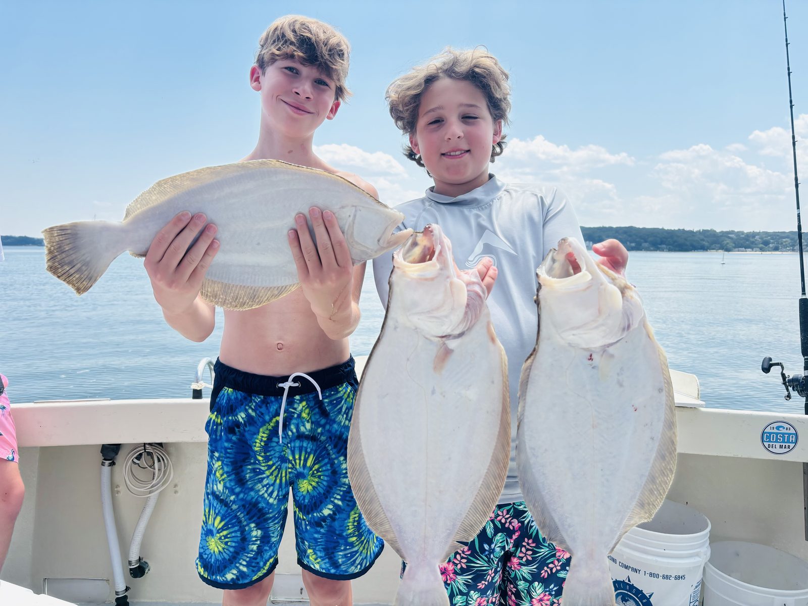 Two young anglers with three fluke