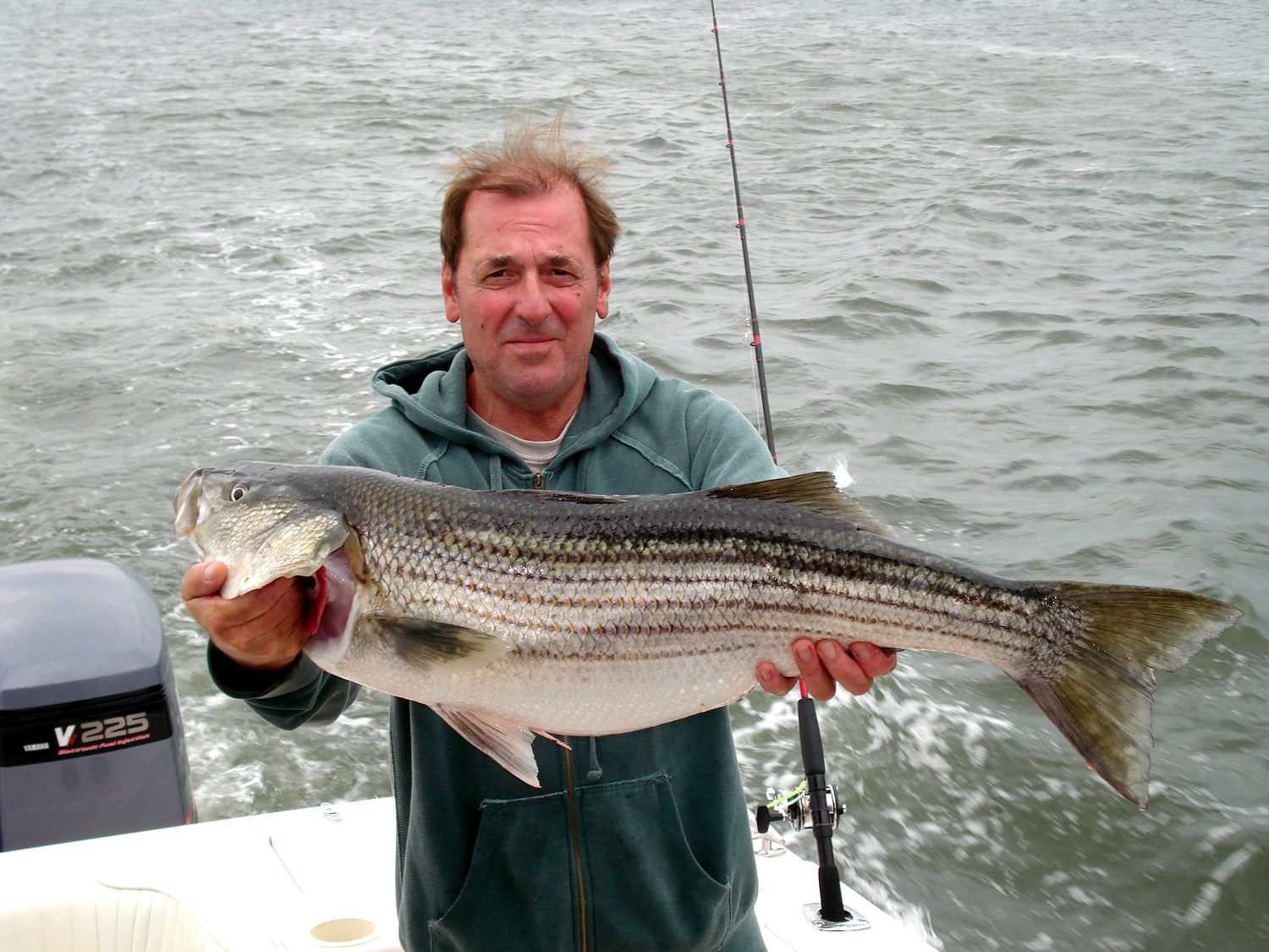 Guest with a large striped bass