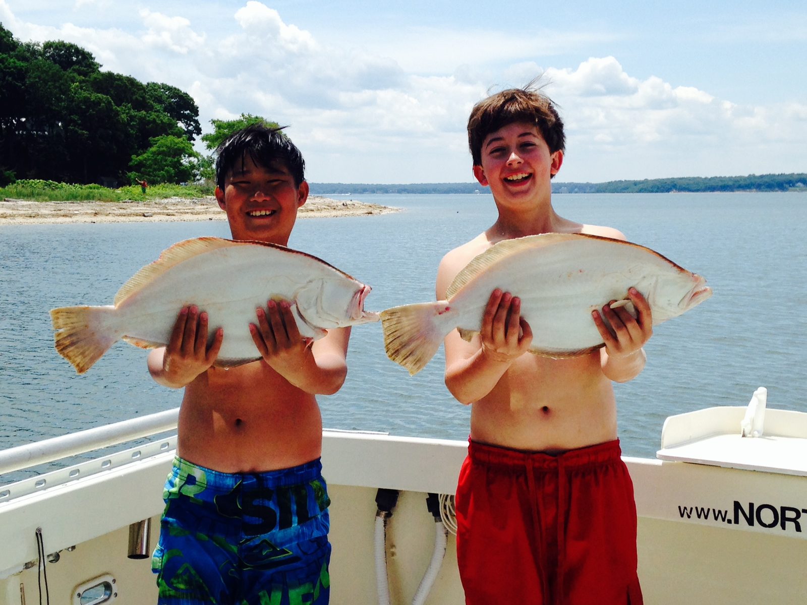 Two campers with a pair of fluke