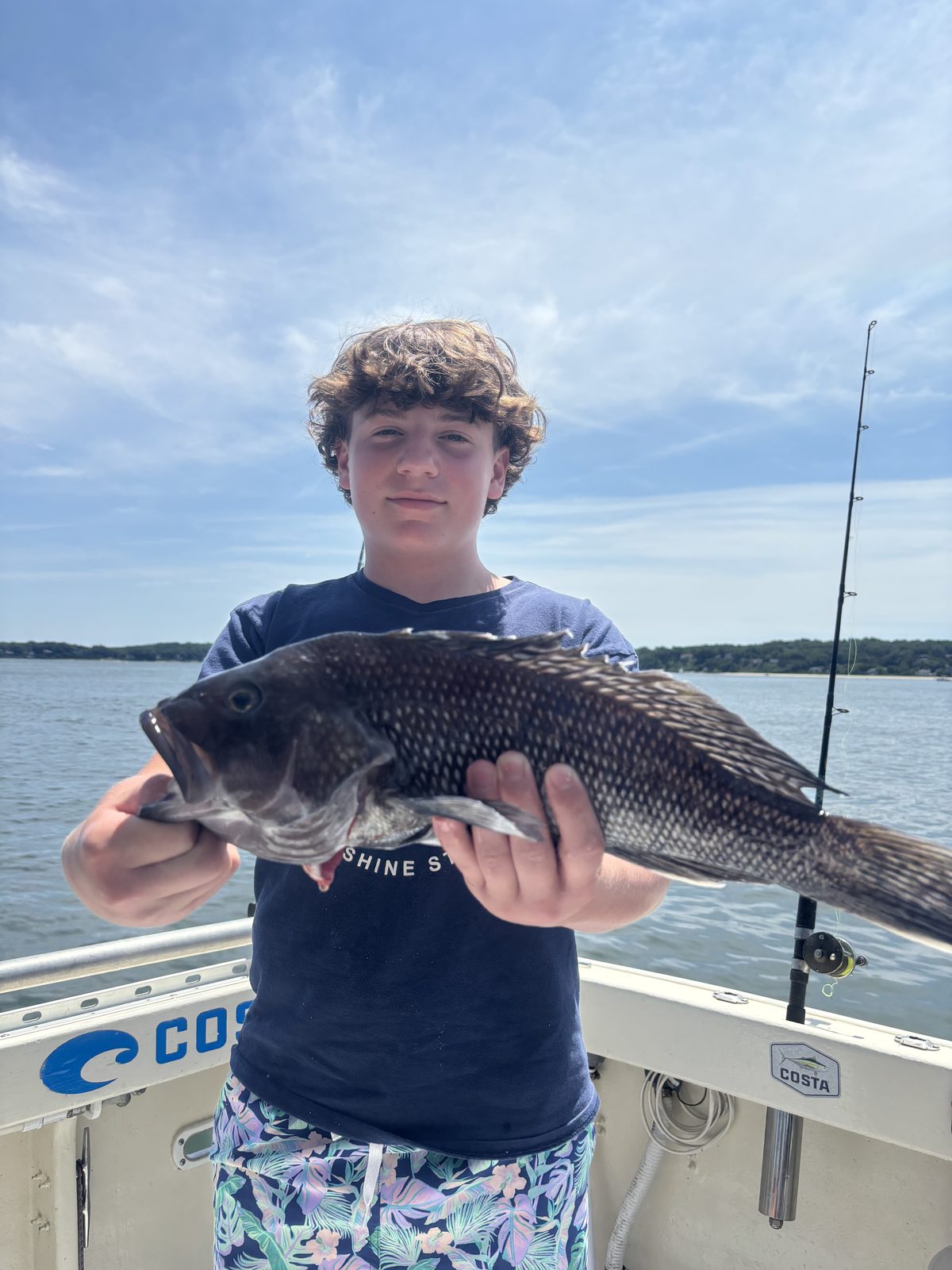 A young angler with a black sea bass