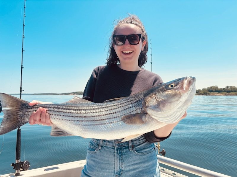 Angler with a striped bass caught off the North Shore