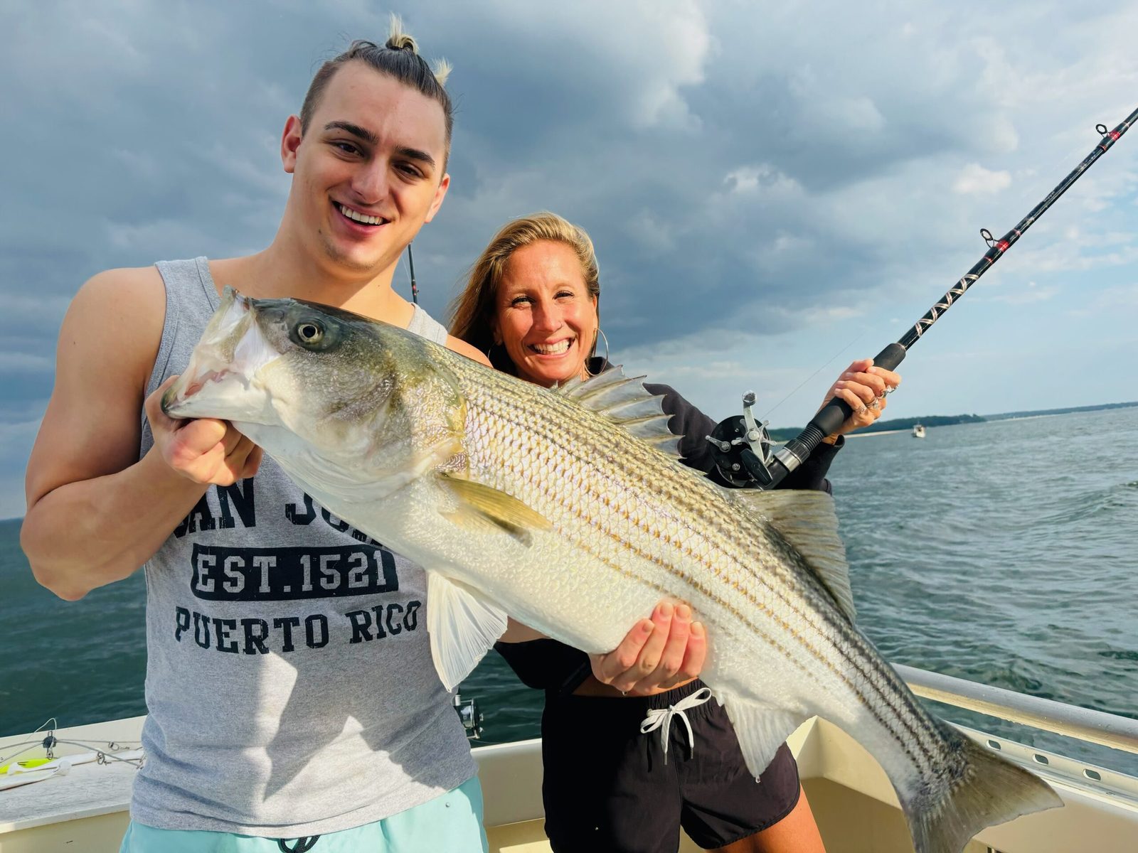 Two guests with a striped bass