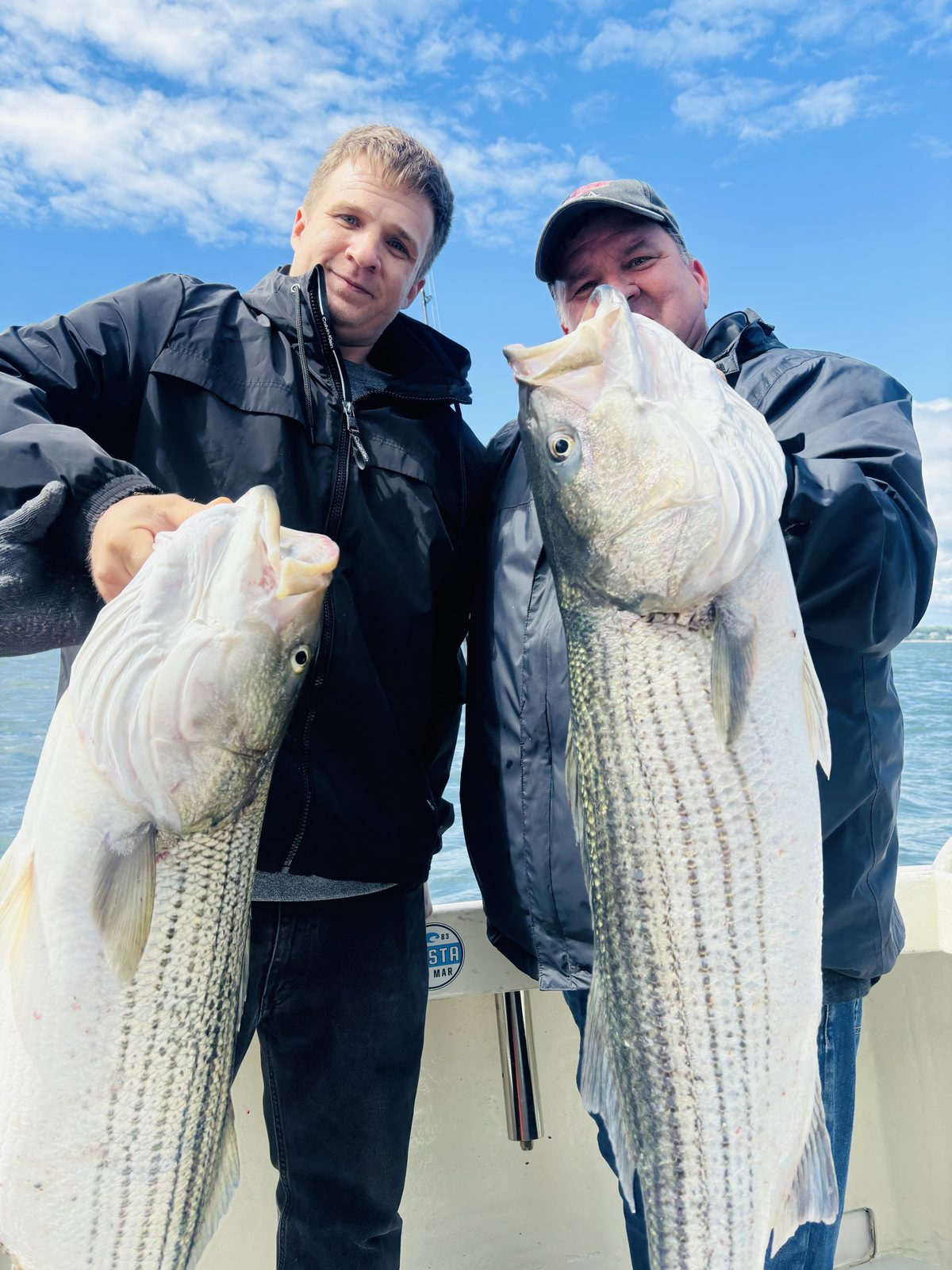 Two anglers with a double header of stripers