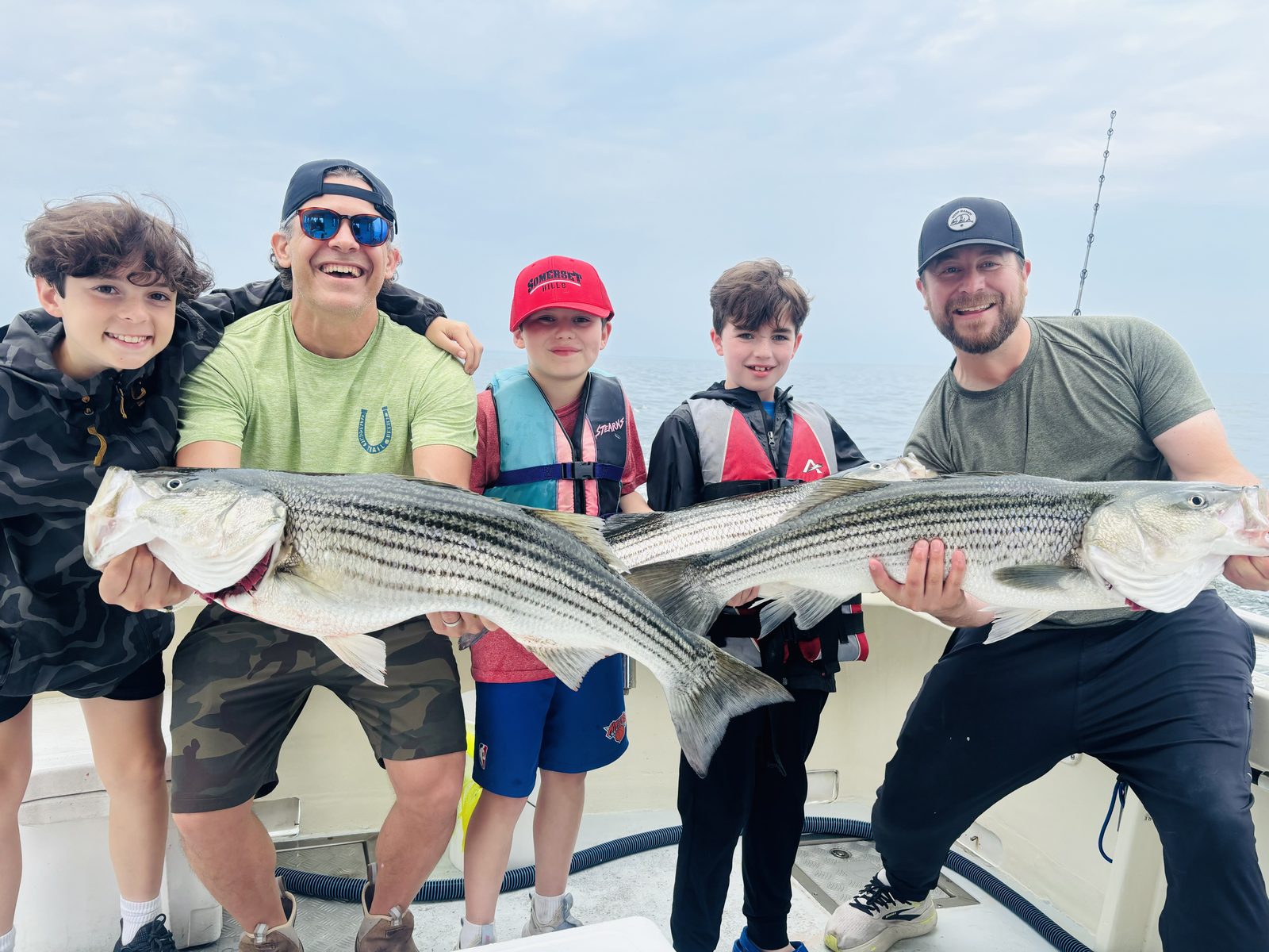 A charter group with two striped bass