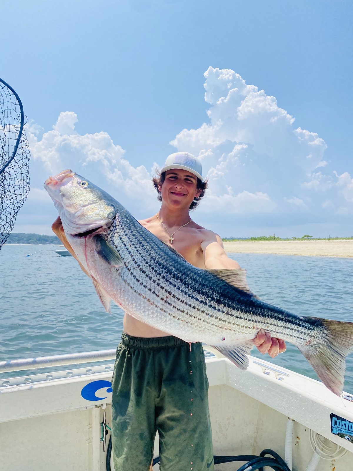 A young angler with a striped bass