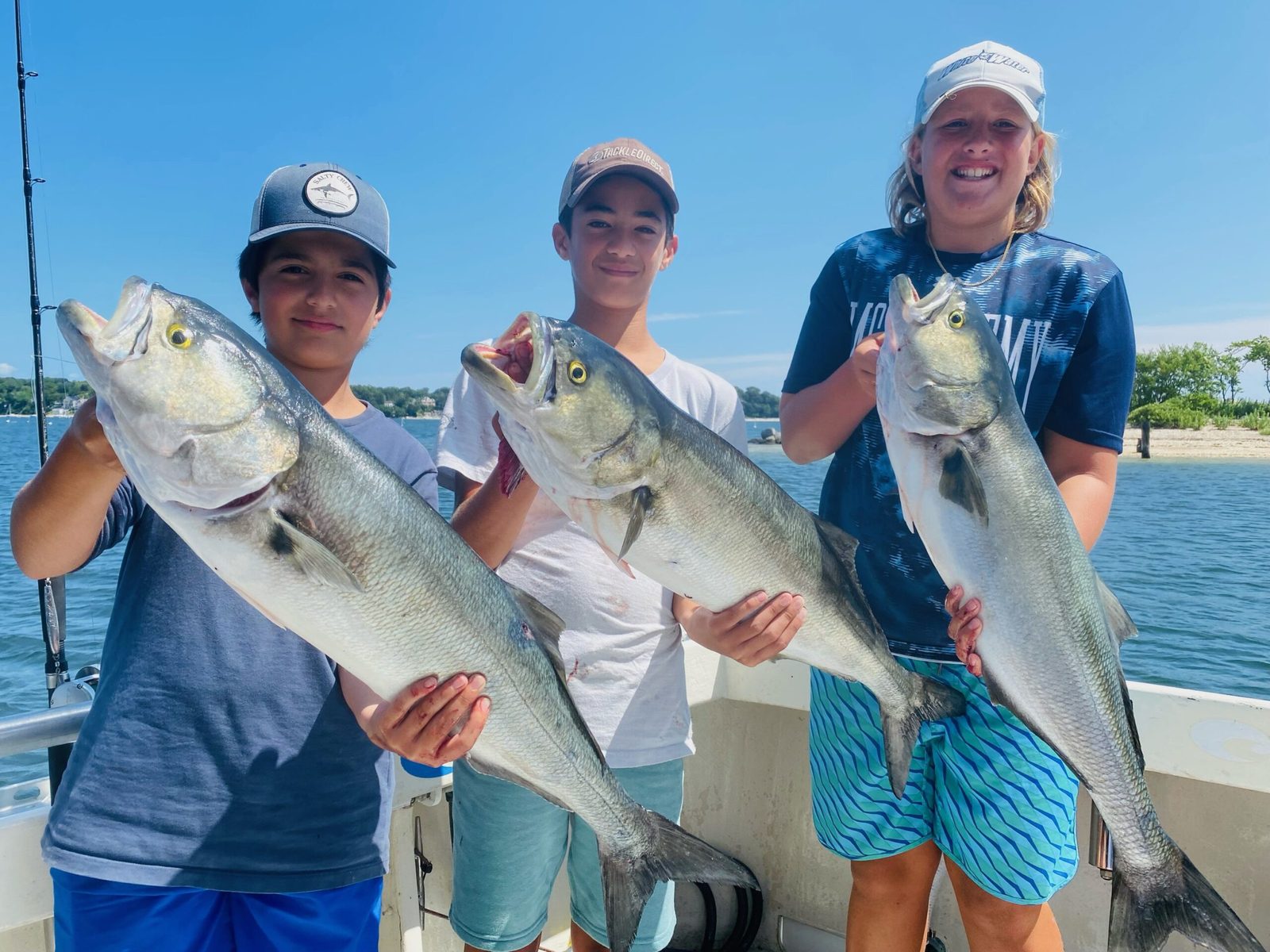 Young anglers with bluefish and bass