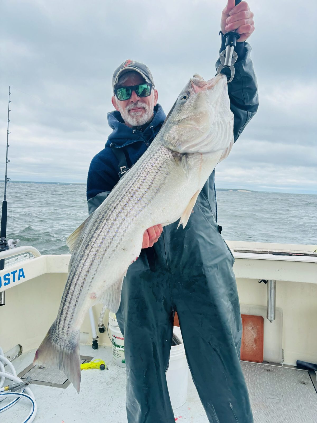A young angler with a striped bass